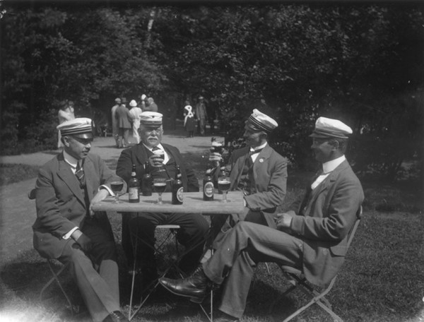 Foto. Odense Håndværker Sangkor. Udflugt. 4 herrer drikker øl ved havebord
